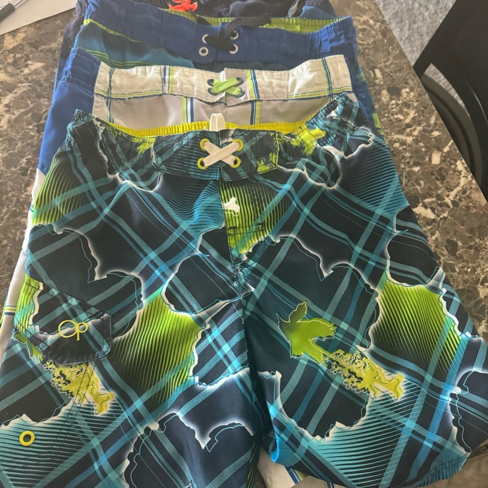 4 pairs of boy swim trunks.